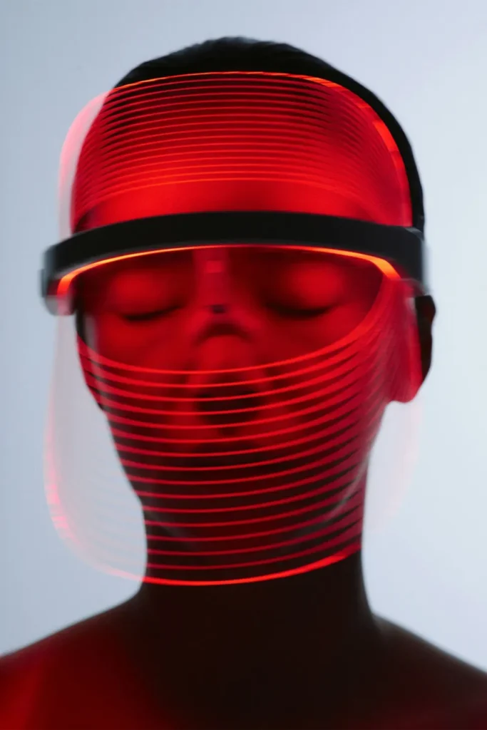 Person wearing a red light therapy device.