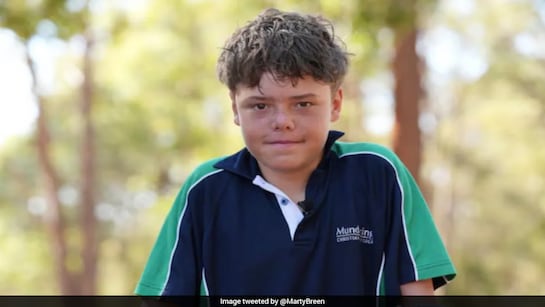 Child outdoors wearing a school uniform.